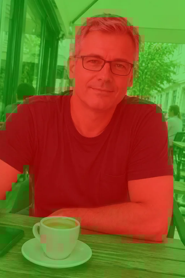 The swapped café photo with V3's heatmap as the dashboard draws it. The red covers the whole man, not only his face, while the street and awning behind him stay mostly green.