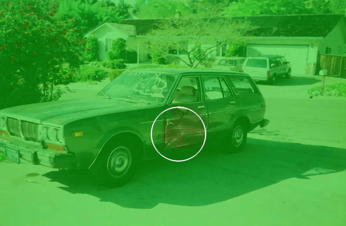 The AI-edited car with V3's heatmap as the dashboard draws it. The white ring marks the strongest cells, which sit on the dent; they reach 26.5%, below the edit level, so the overlay stays green.